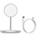 Black magnetic wireless charging stand holding an iPhone 12 upright on a desk.