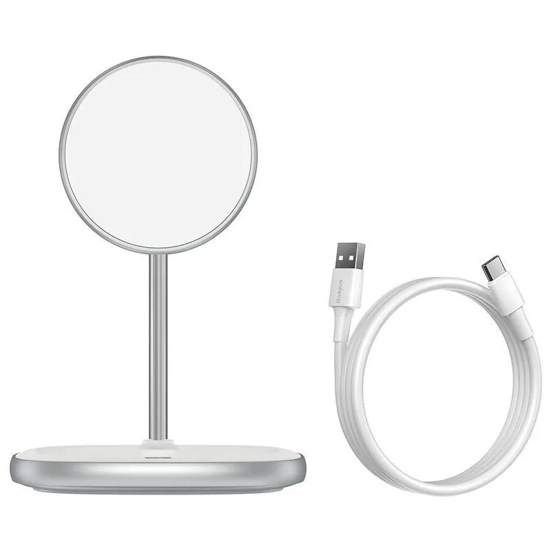Black magnetic wireless charging stand holding an iPhone 12 upright on a desk.