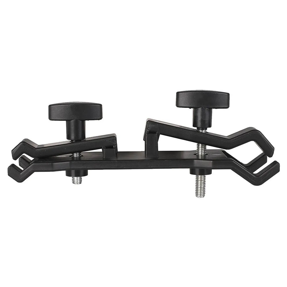 Black plastic umbrella clip attached to camera tripod holding smartphone under umbrella