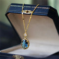 Gold geometric pendant necklace with a French retro design on a model.