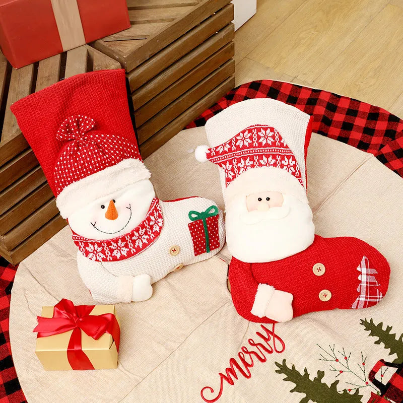 Large red and white knitted Christmas stocking with Santa Claus design hanging on a fireplace