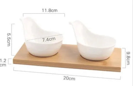 White porcelain snack dish with compartments on a wooden board