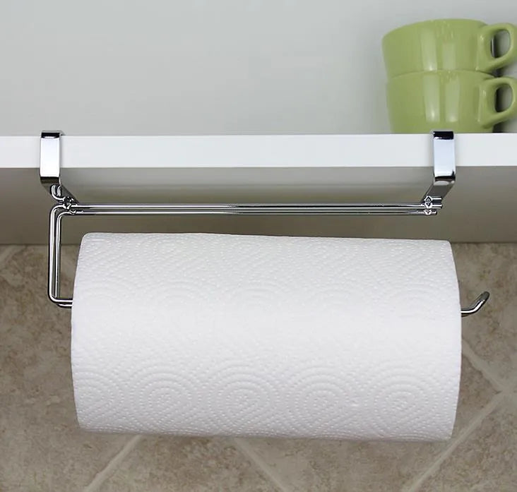 Silver stainless steel kitchen towel rack mounted on a cabinet door holding a paper towel roll.