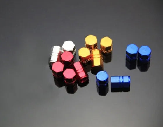 Set of five aluminium alloy car valve caps in black, blue, gold, red, and silver, designed for tyre valve stems with screw-on threading.