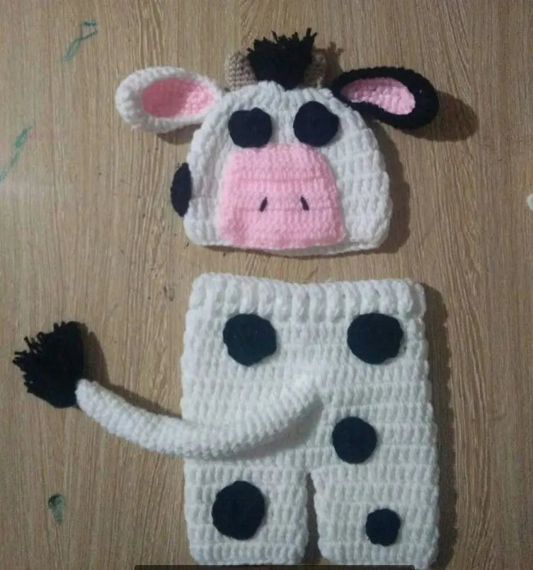 Hand-knitted white baby cow suit with matching pants and hat for newborns