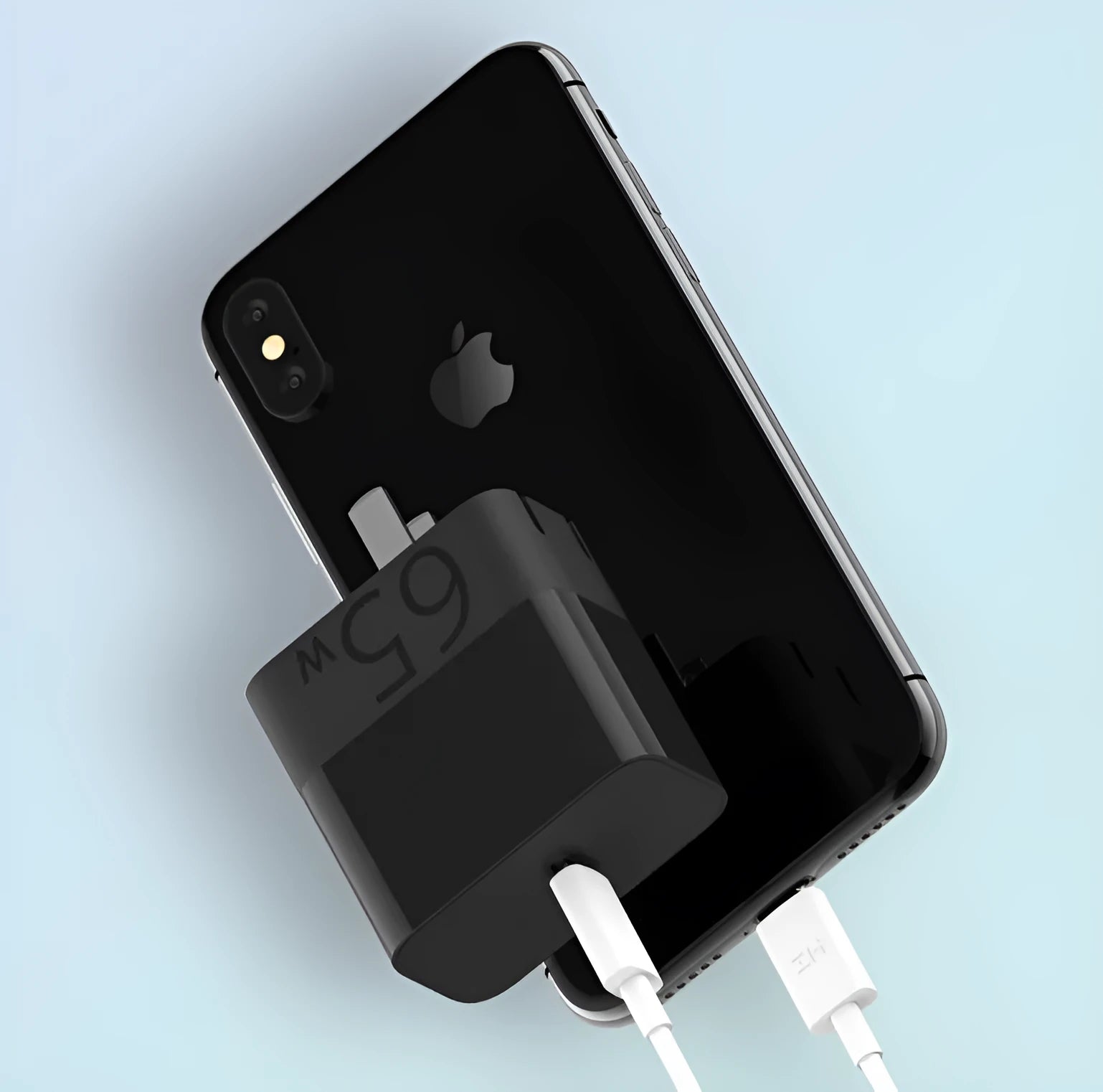 Black ZMI USB-C 65W notebook power adapter showing compact size next to a USB-C cable.