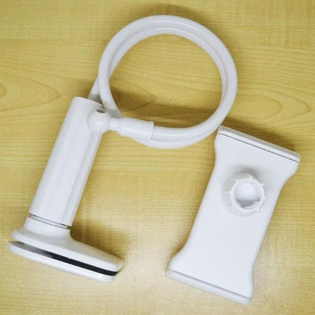 Black bedside oversize flat panel handset holder with a long arm on a wooden table.