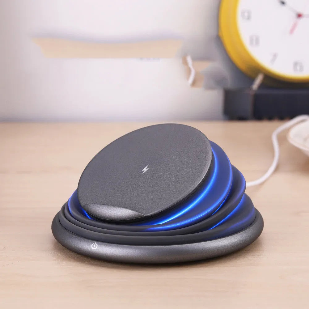 Grey wireless charger pad with silicone surface on a desk, 138mm square shape