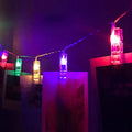 LED photo holder string lights with warm white bulbs and photo clips on a window display