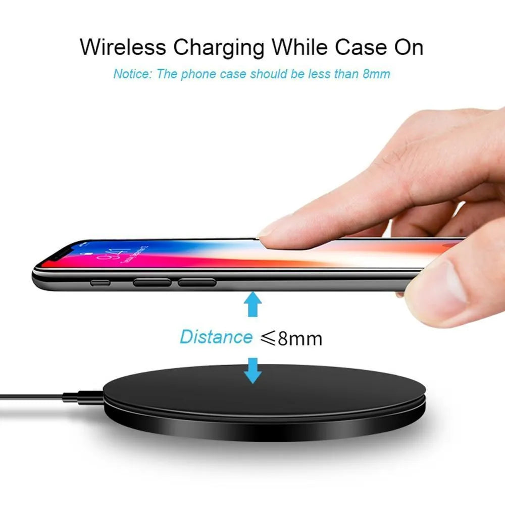 Black ultra-thin square wireless fast charger with USB cable on a desk