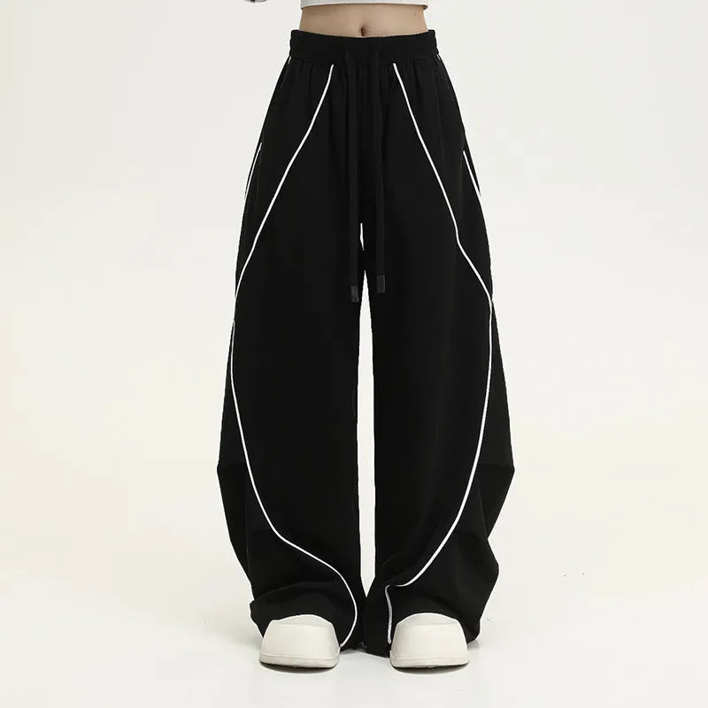 Black pleated wide-leg hip hop sports trousers with striped pattern on a mid waist.
