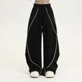 Black pleated wide-leg hip hop sports trousers with striped pattern on a mid waist.