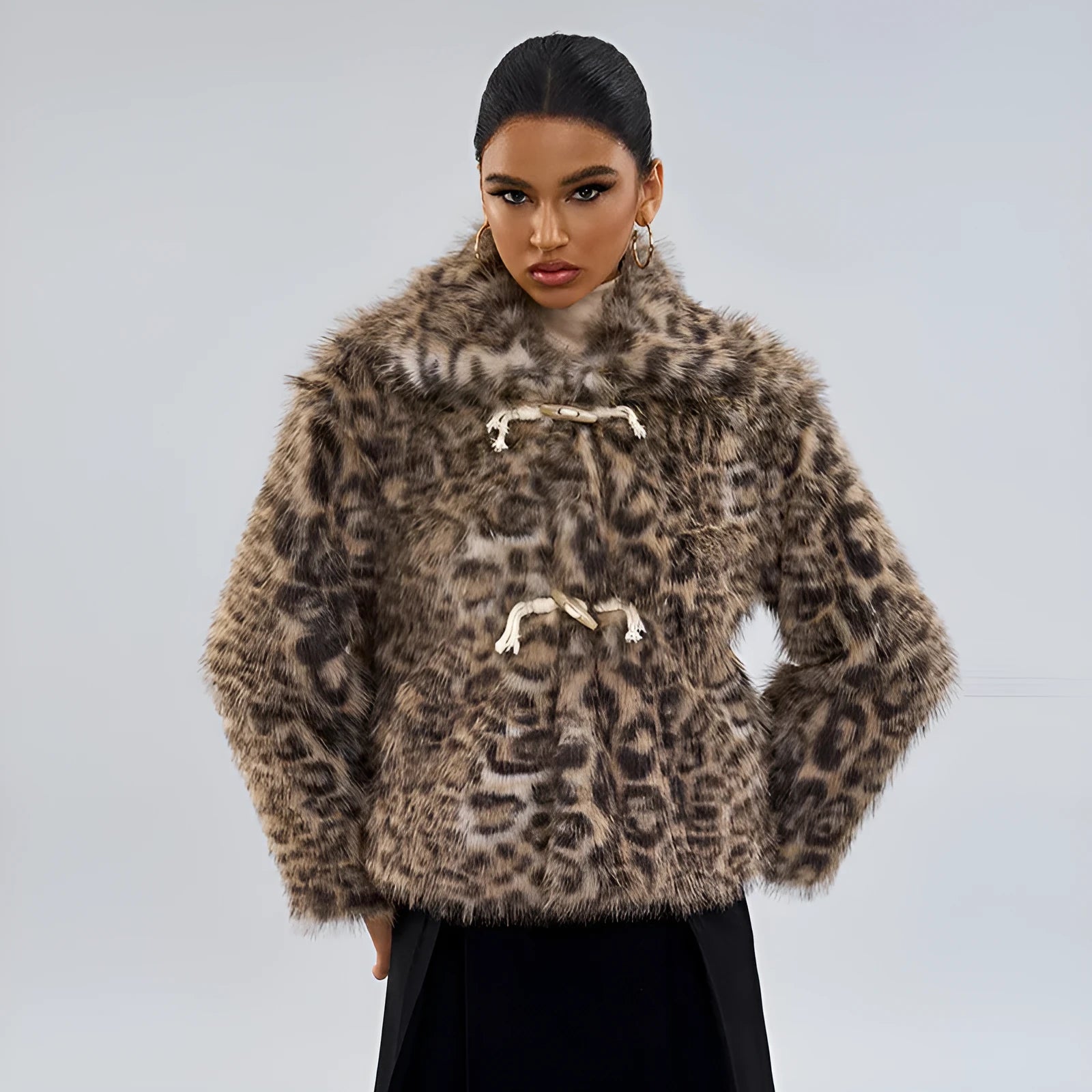 Women's leopard print coat with a buckle lapel closure on a street fashion model.