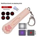 Small white infrared laser cat teasing stick with LED light, shown on a table with a USB charging cable.