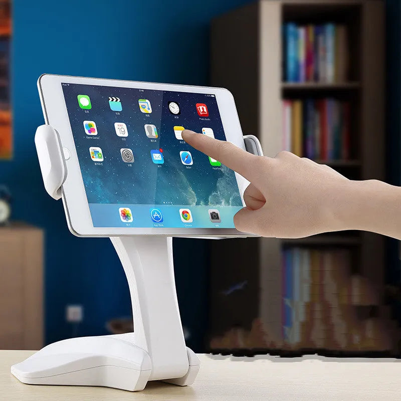 White adjustable tablet stand with metal frame and silicone clip, holding a tablet on a desk.