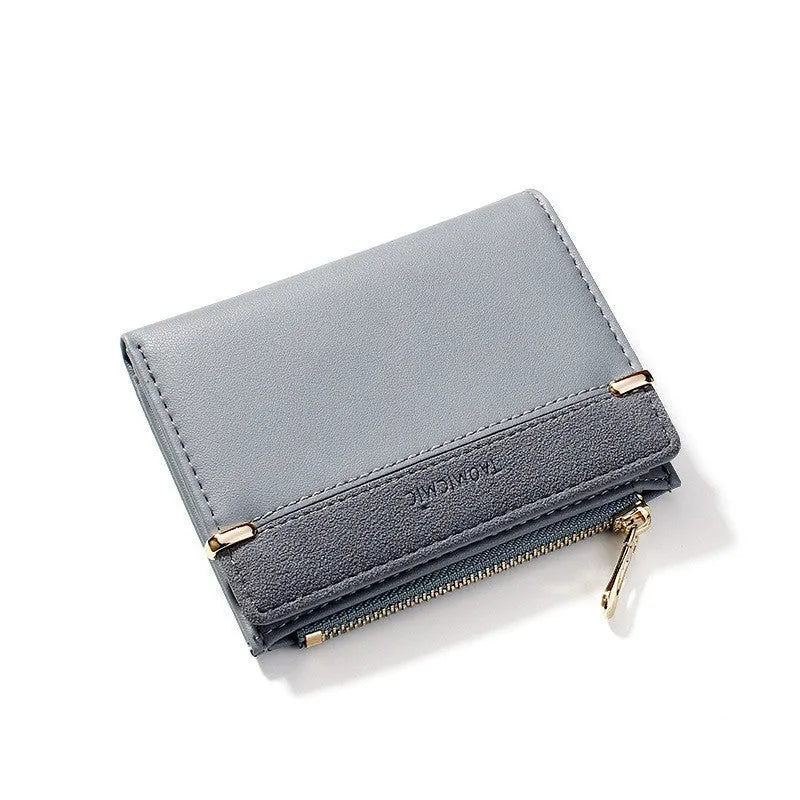 Compact black PU leather ladies wallet open to show card slots, bill compartment, change slot, and zippered section.