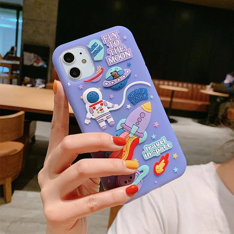 Purple silicone iPhone case with cartoon astronaut graphic for models 7, 8, X, and 11