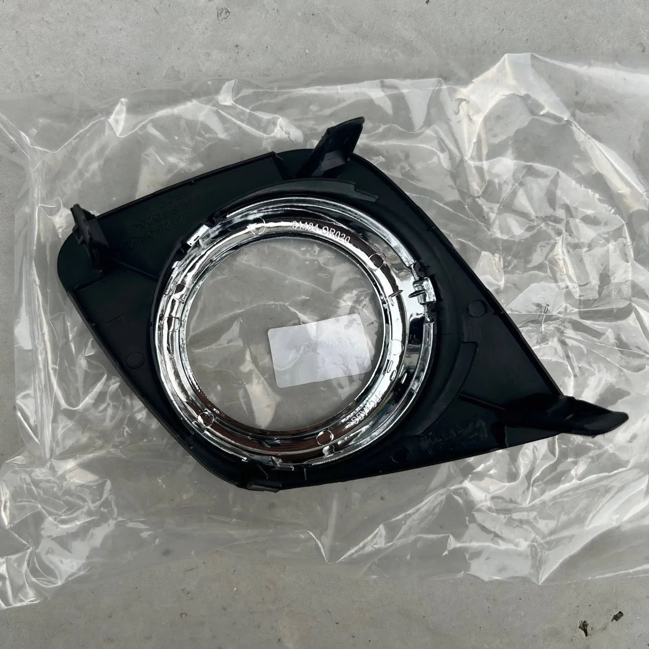 Black anti-fog light cover trim piece for Toyota RAV4 front bumper.