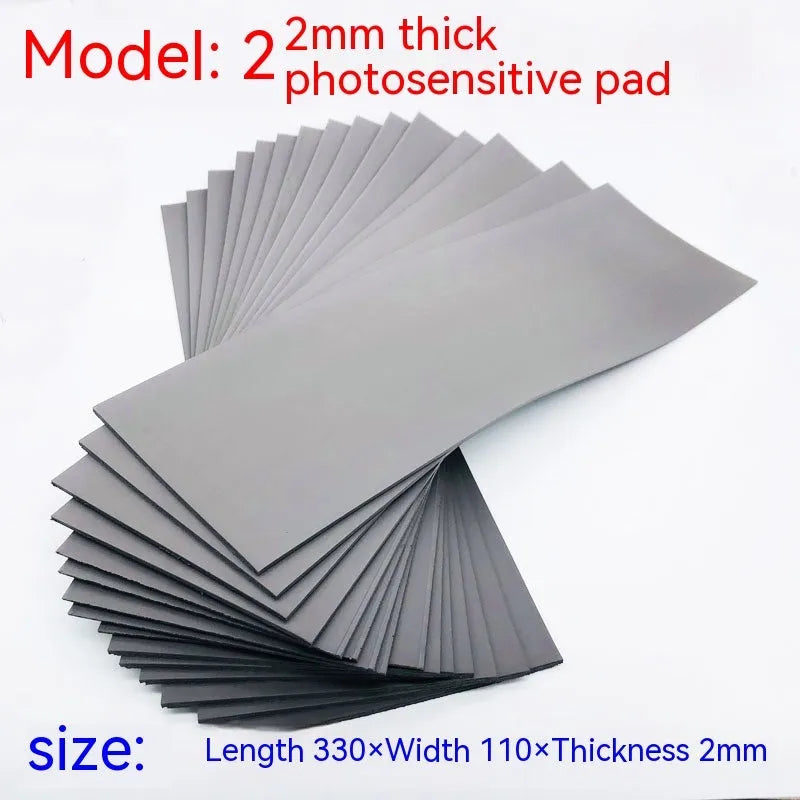 Black and grey plastic light-sensitive mat for seal carving in three thicknesses.