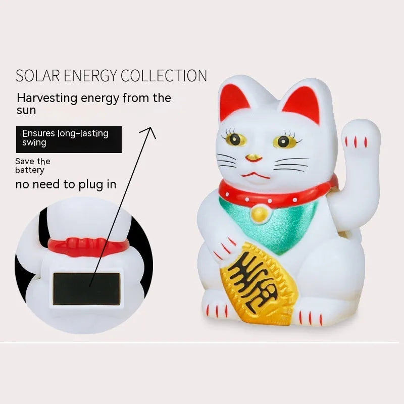 Yellow solar Maneki Neko lucky cat waving its arm on a car dashboard.