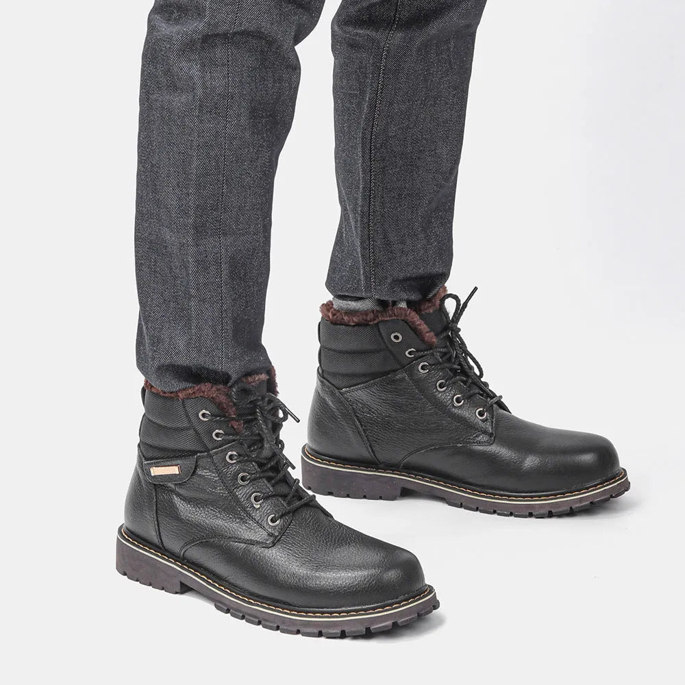 Pair of black plus size men's cowhide leather snow boots with fleece lining, mid-calf height and rubber sole.