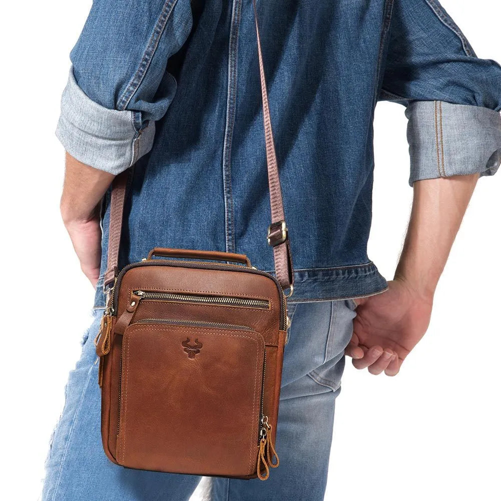 Men's brown Crazy Horse leather crossbody bag with visible sewing lines and adjustable shoulder strap