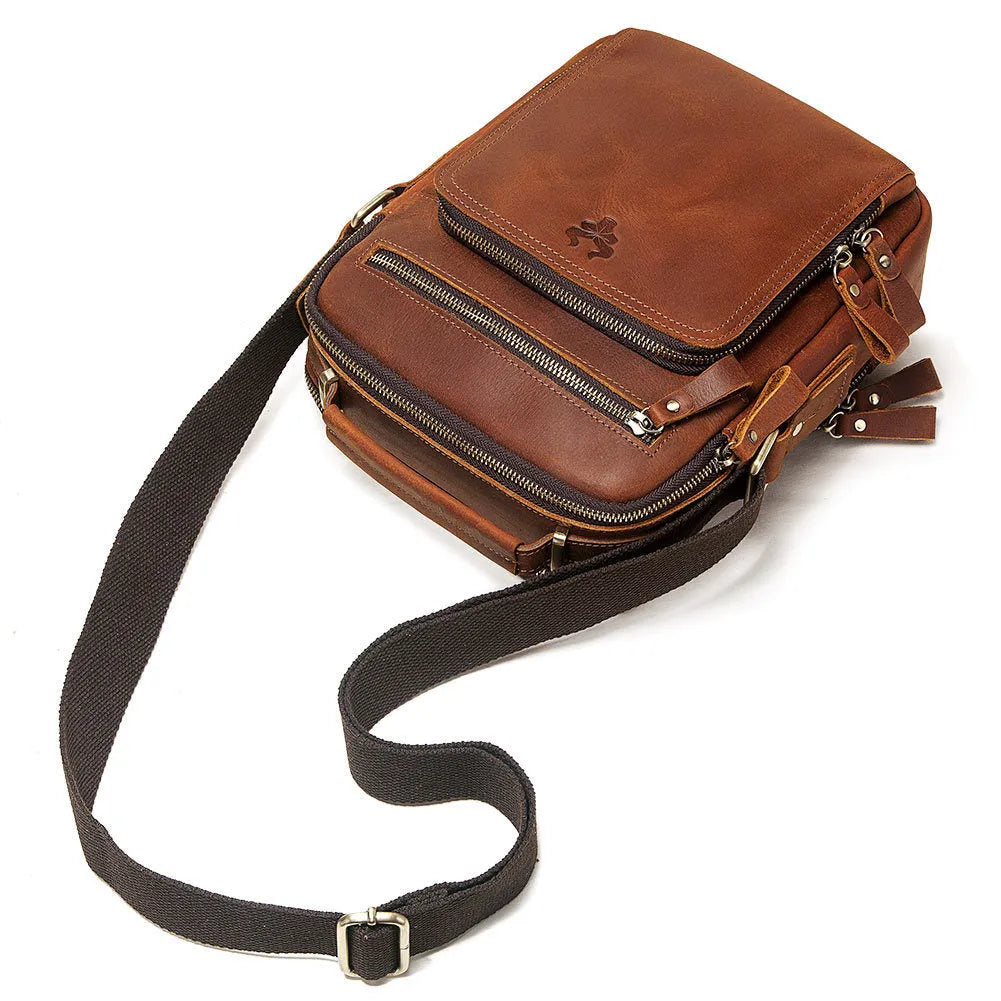 Men's brown Crazy Horse leather crossbody bag with visible sewing lines and adjustable shoulder strap
