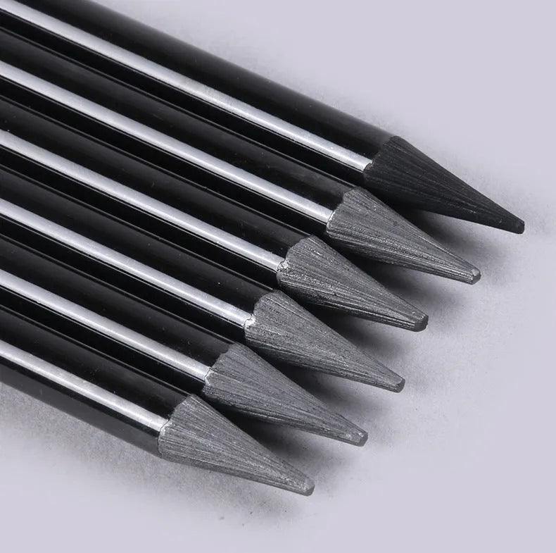 Set of six graphite and three carbonized pencils with wooden casings on a retail suction card.