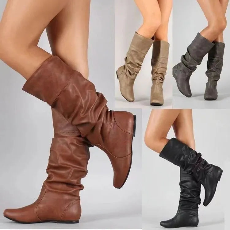 Women's flat black slip-on ankle boots with a round toe and high-top design on a neutral background.