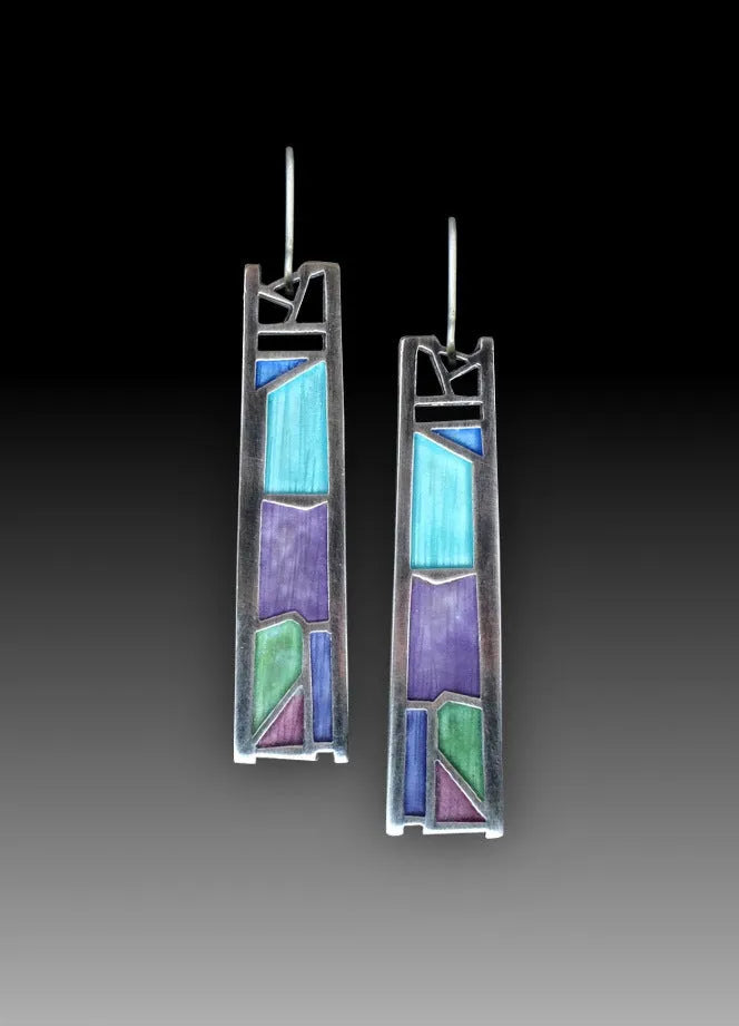 Silver-coloured women's earrings in a water drop shape with an irregular, textured edge design.