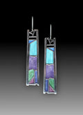 Silver-coloured women's earrings in a water drop shape with an irregular, textured edge design.