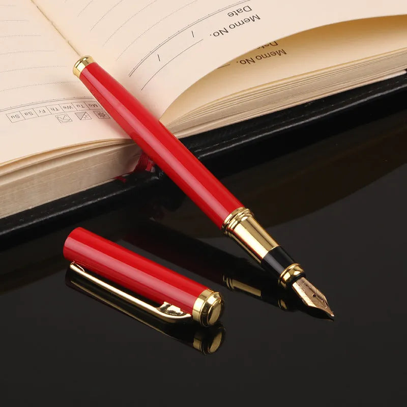 Red and black metal ballpoint pen with a 0.5mm stainless steel nib on a notepad.