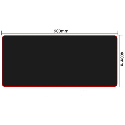 All black extra long desk pad with overlock stitching on a wooden desk with keyboard and mouse