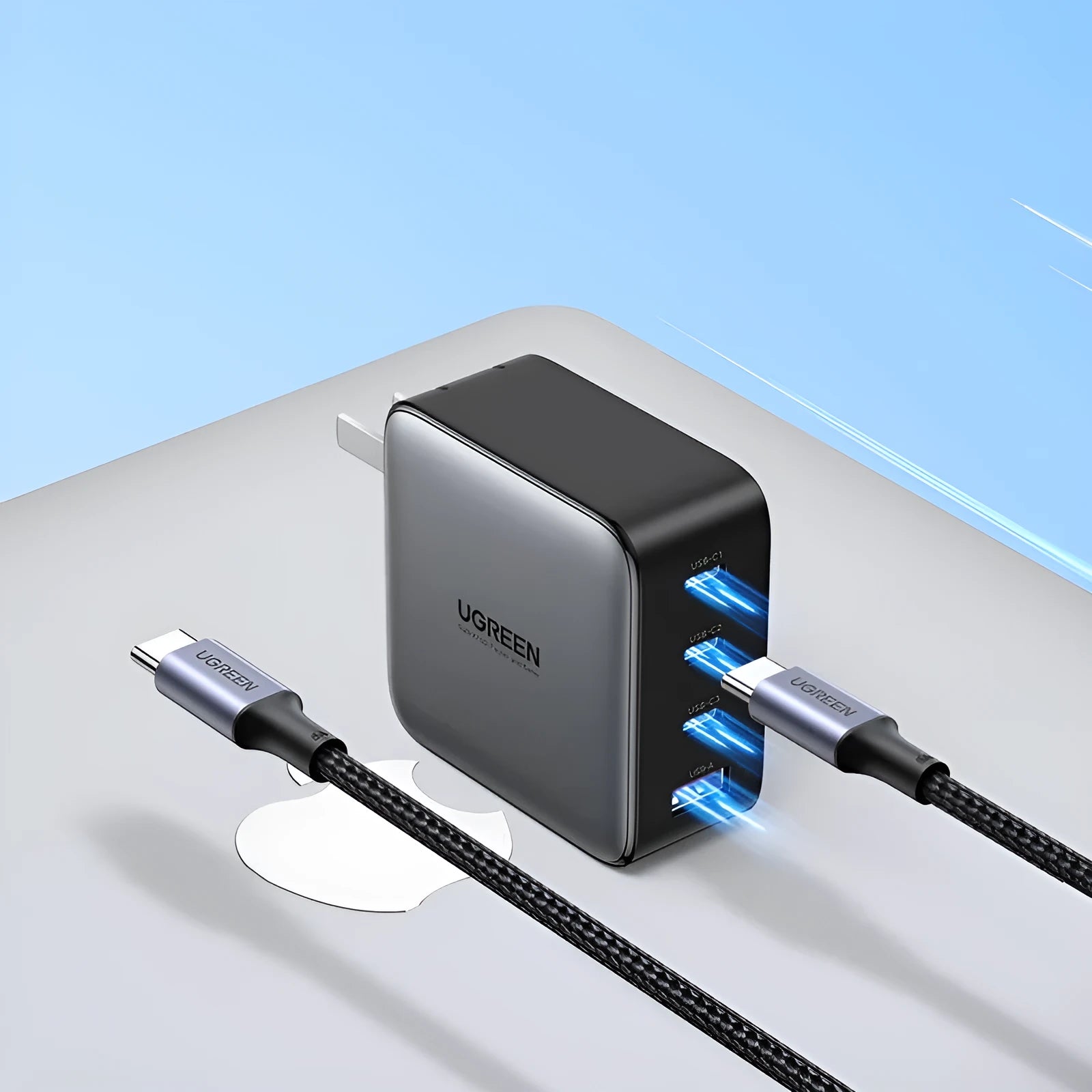 100W Gallium Nitride multi-port USB-C charger plug with attached cable on a grey background.