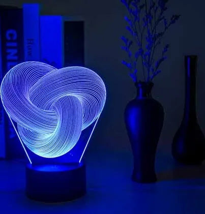 Twist abstract LED 3D night light in colour gradient mode on a wooden table with remote control