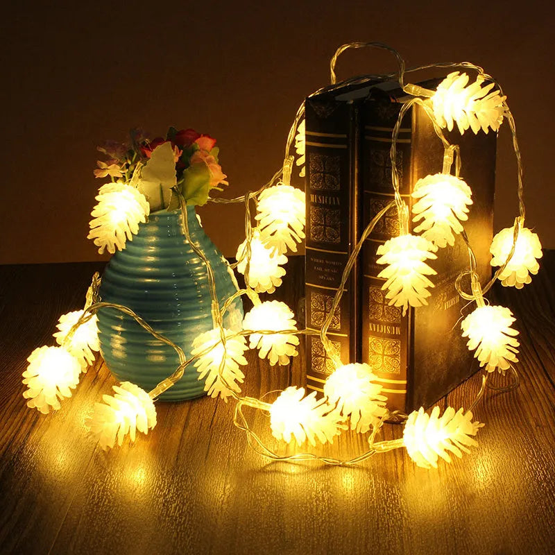 Warm white LED pine cone fairy lights on a string, battery-powered for indoor and outdoor decorative use.