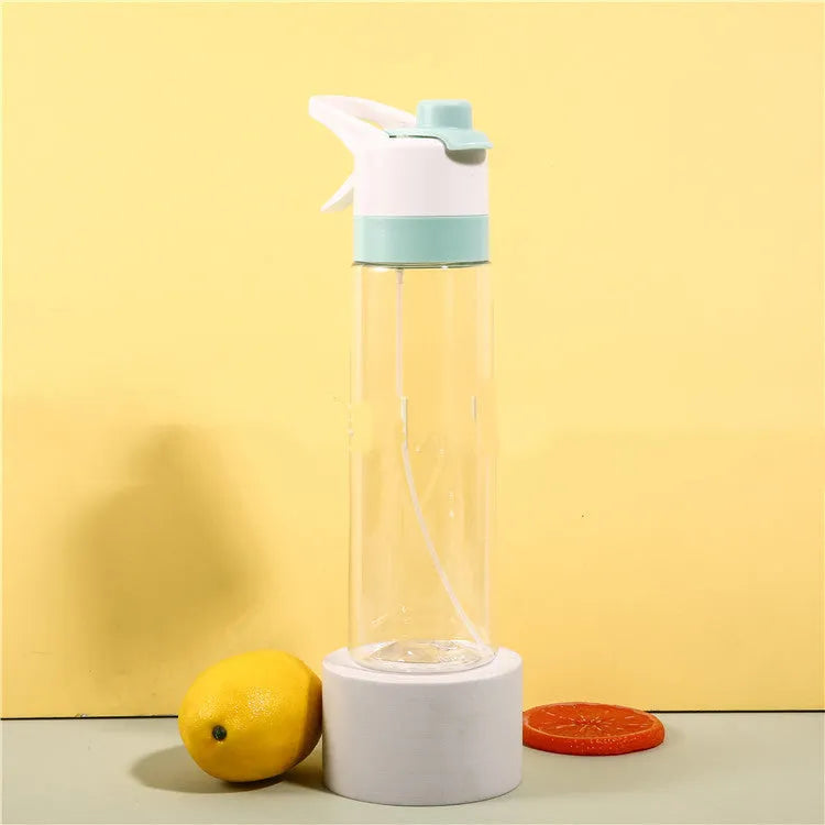 White plastic spray water bottle with handle strap and leakproof lid on a gym bag.