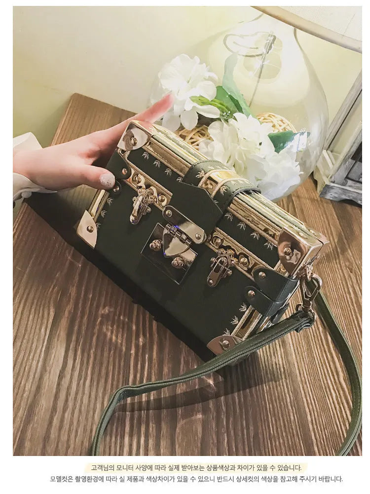 Women's structured black PU shoulder bag with flap and adjustable crossbody strap