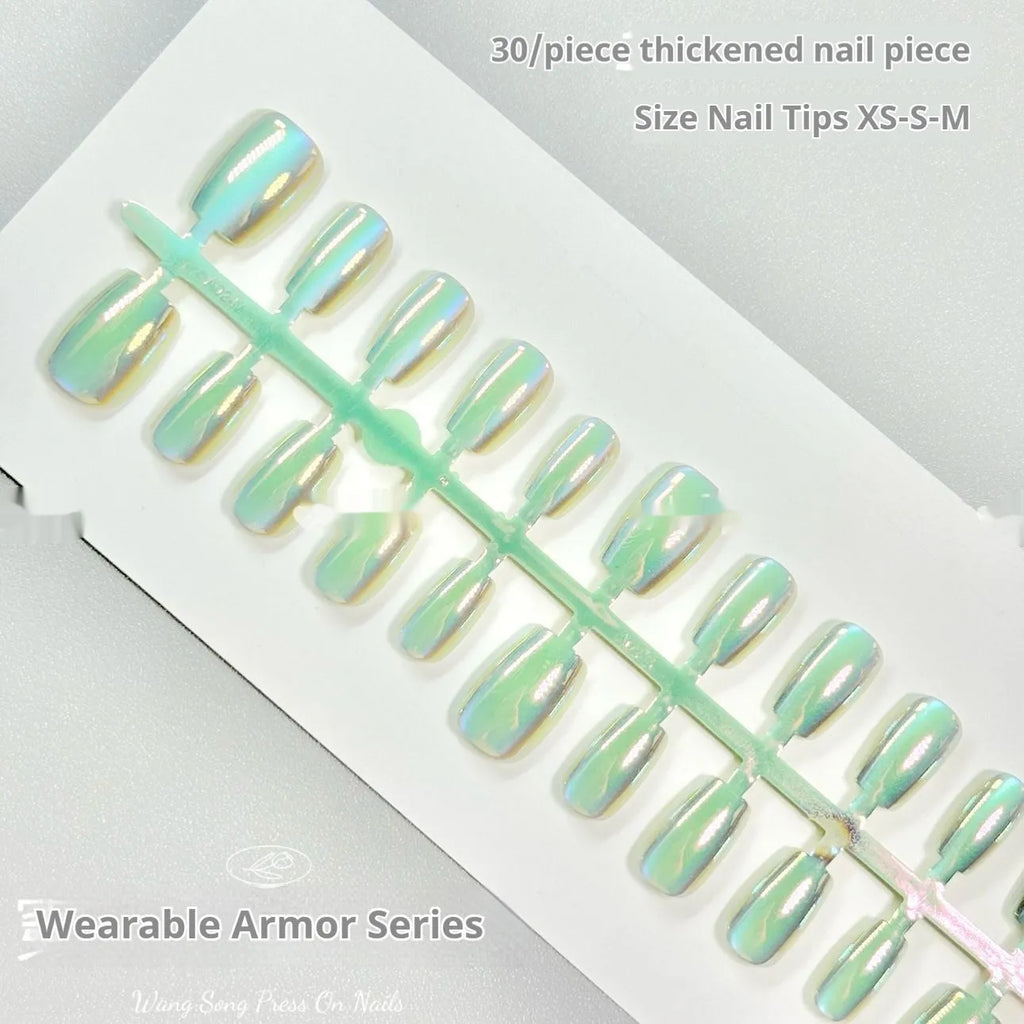 Set of electroplated Cat's Eye and aurora press-on nails in short ladder sizes on a white background.
