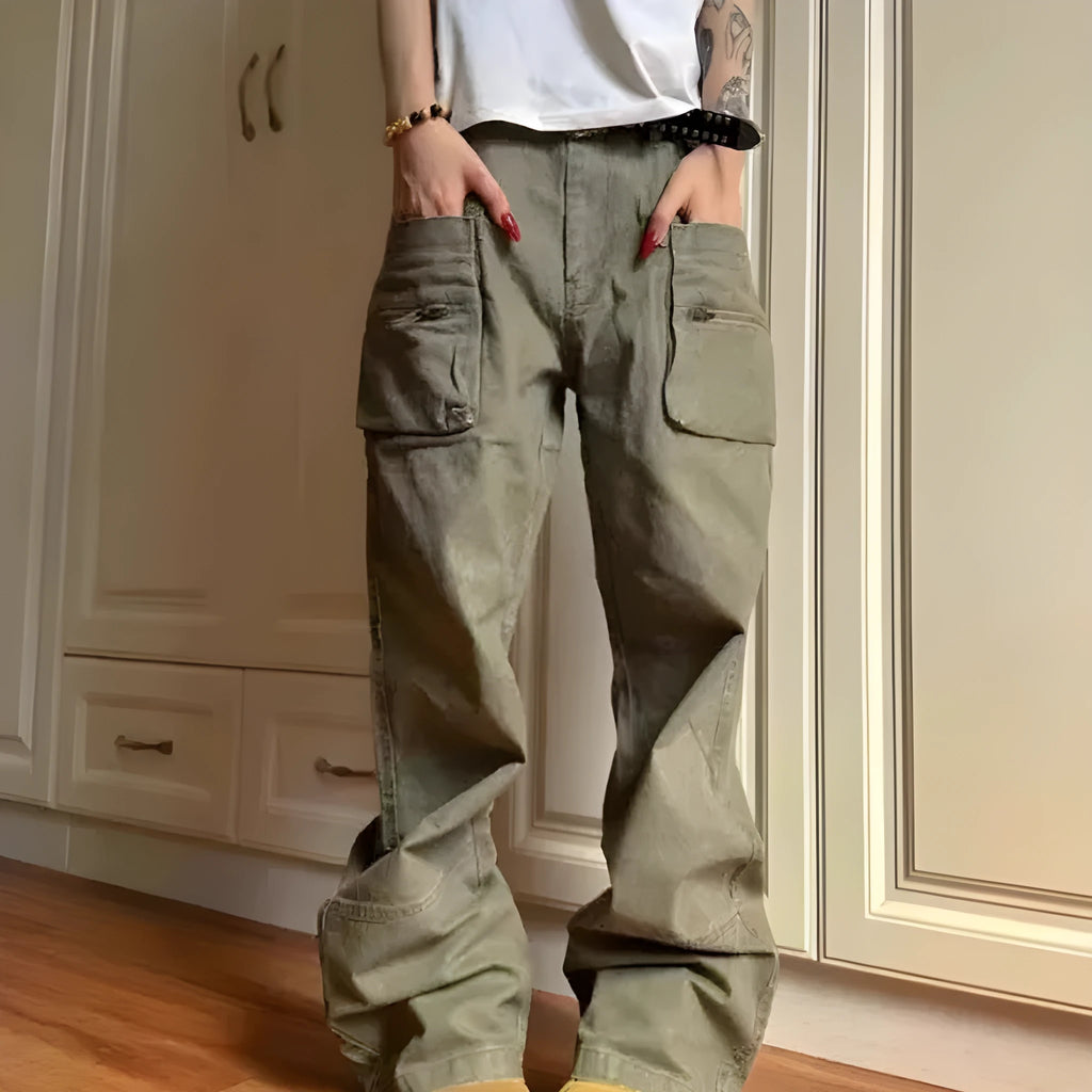 Green and black double zipper casual cotton pants with an elasticated waistband on a hanger.