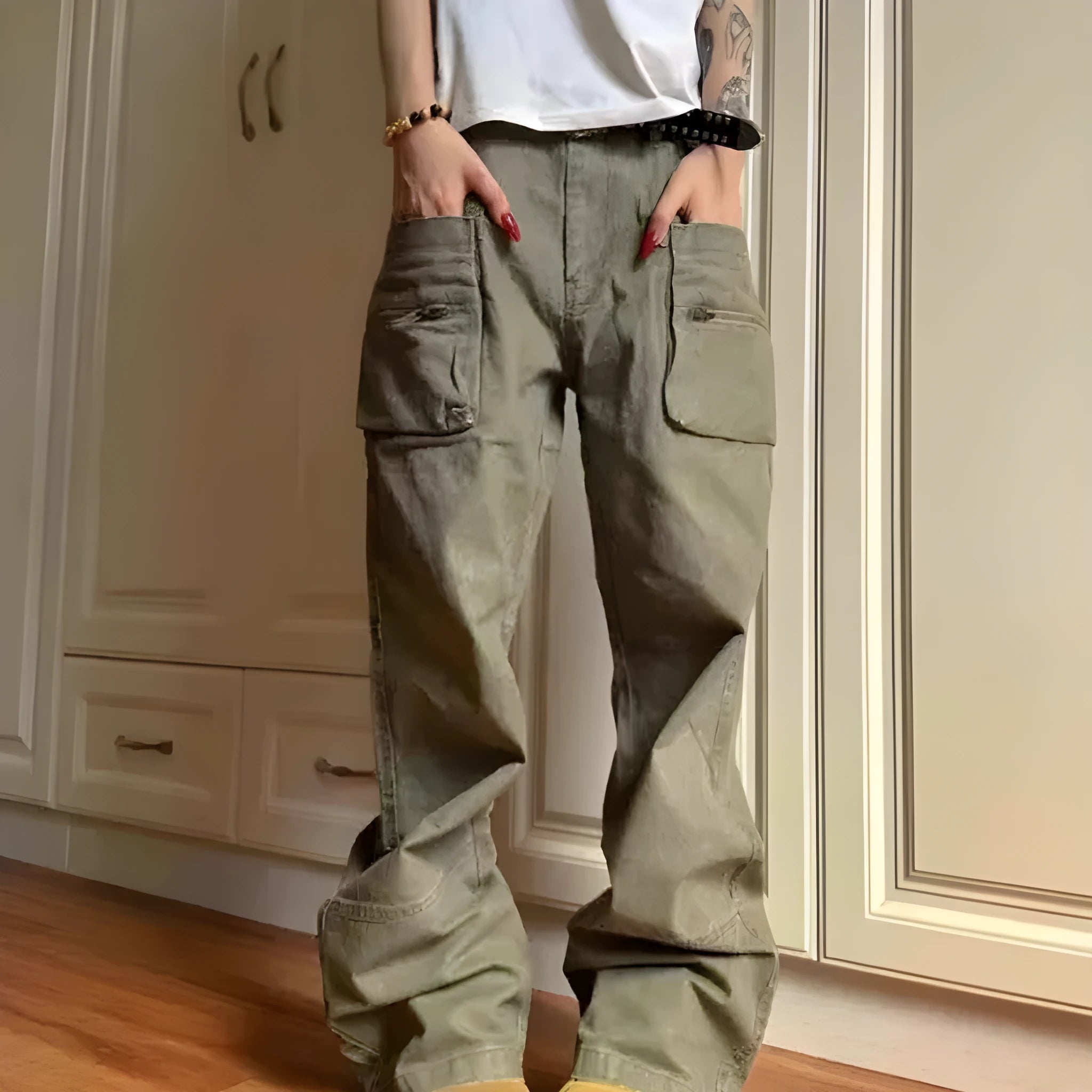 Green and black double zipper casual cotton pants with an elasticated waistband on a hanger.