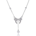 Silver necklace with heart-shaped pendant featuring bow detail on O-ring chain