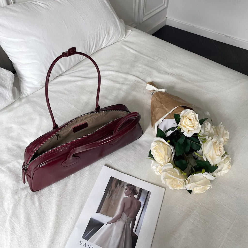 Retro genuine leather baguette bag in wine red with oval shape and sandwich pocket