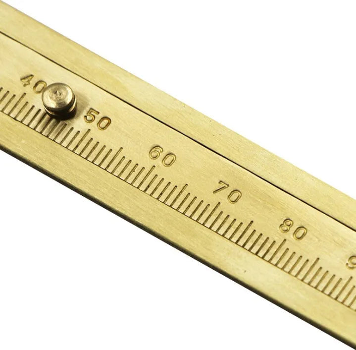 Double scale mini copper caliper 100mm brass vernier with clear markings on wooden surface