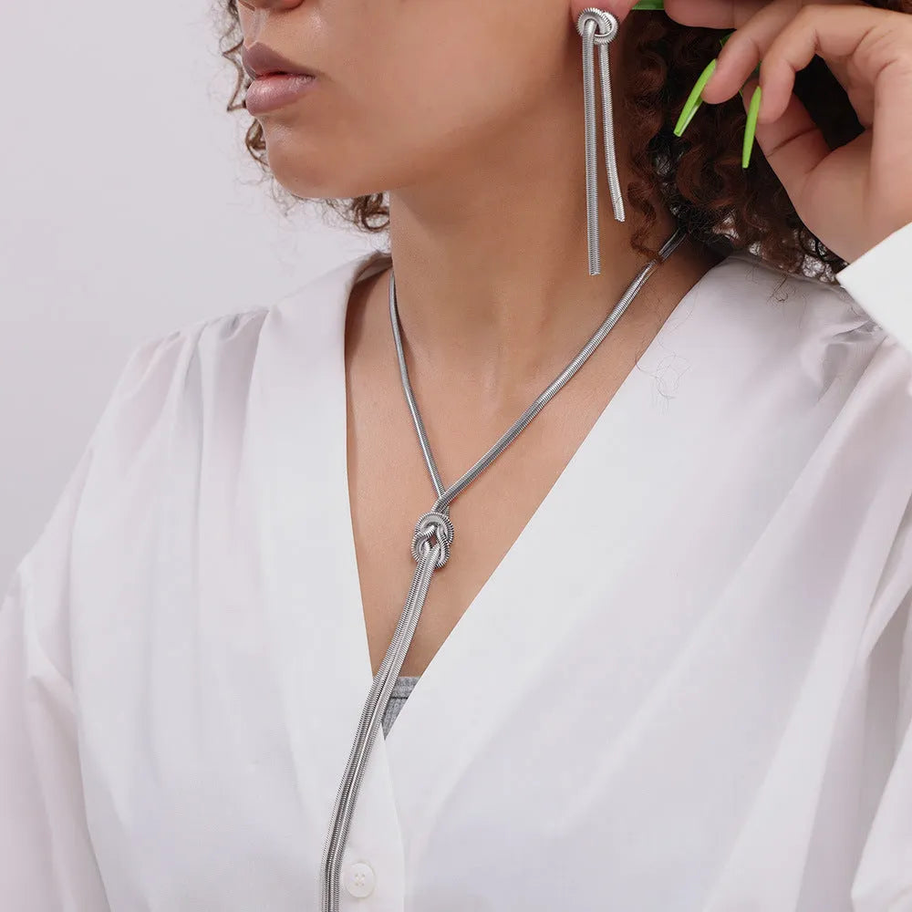 Women's gold knotted tassel necklace on snake chain with matching titanium steel earrings