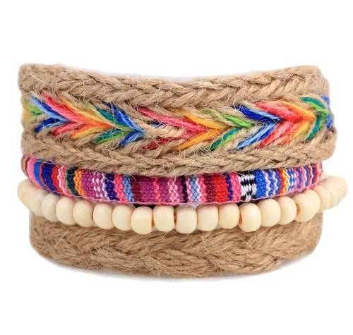 Handmade brown leather wrap bracelet with wooden beads and braided cord on a wrist.