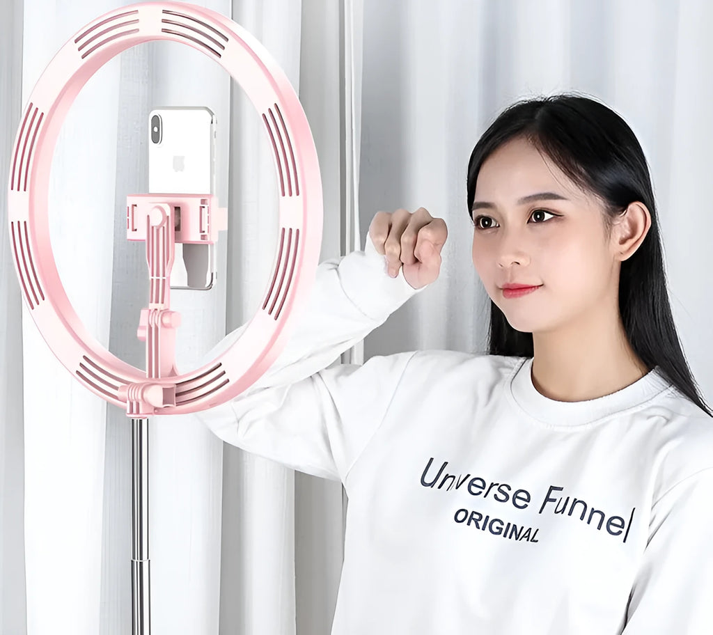 Portable 290mm LED selfie ring light in black on table, showing centre phone holder and adjustable brightness button
