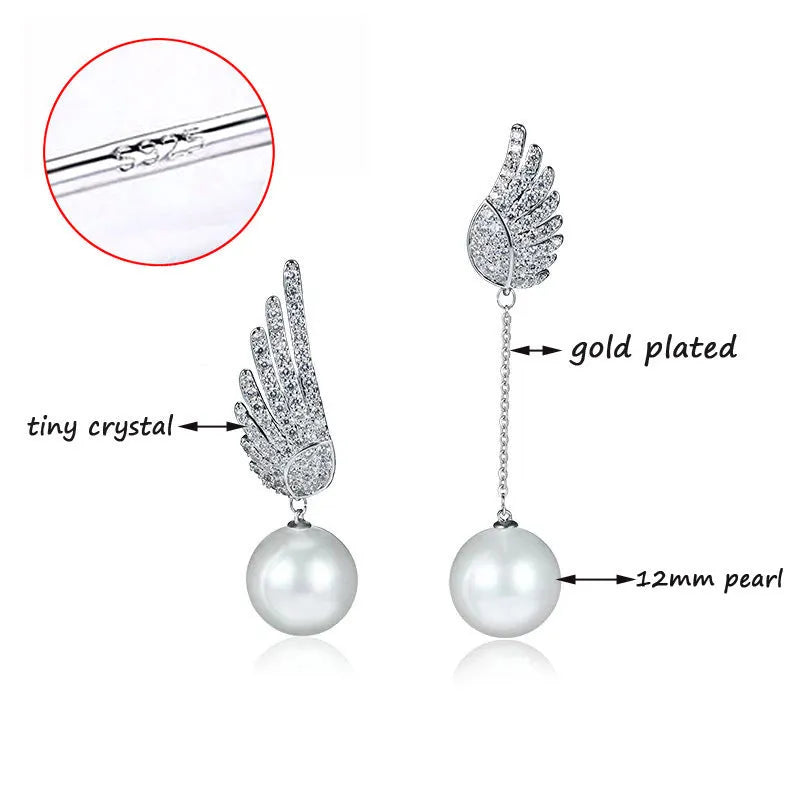 Silver angel wing earrings with diamond-cut treatment and gemstone inlay on platinum background