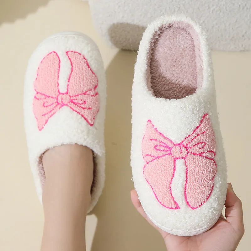 Pink and blue cotton suede slippers with a cartoon bow knot design and TPR sole.