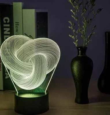 Twist abstract LED 3D night light in colour gradient mode on a wooden table with remote control